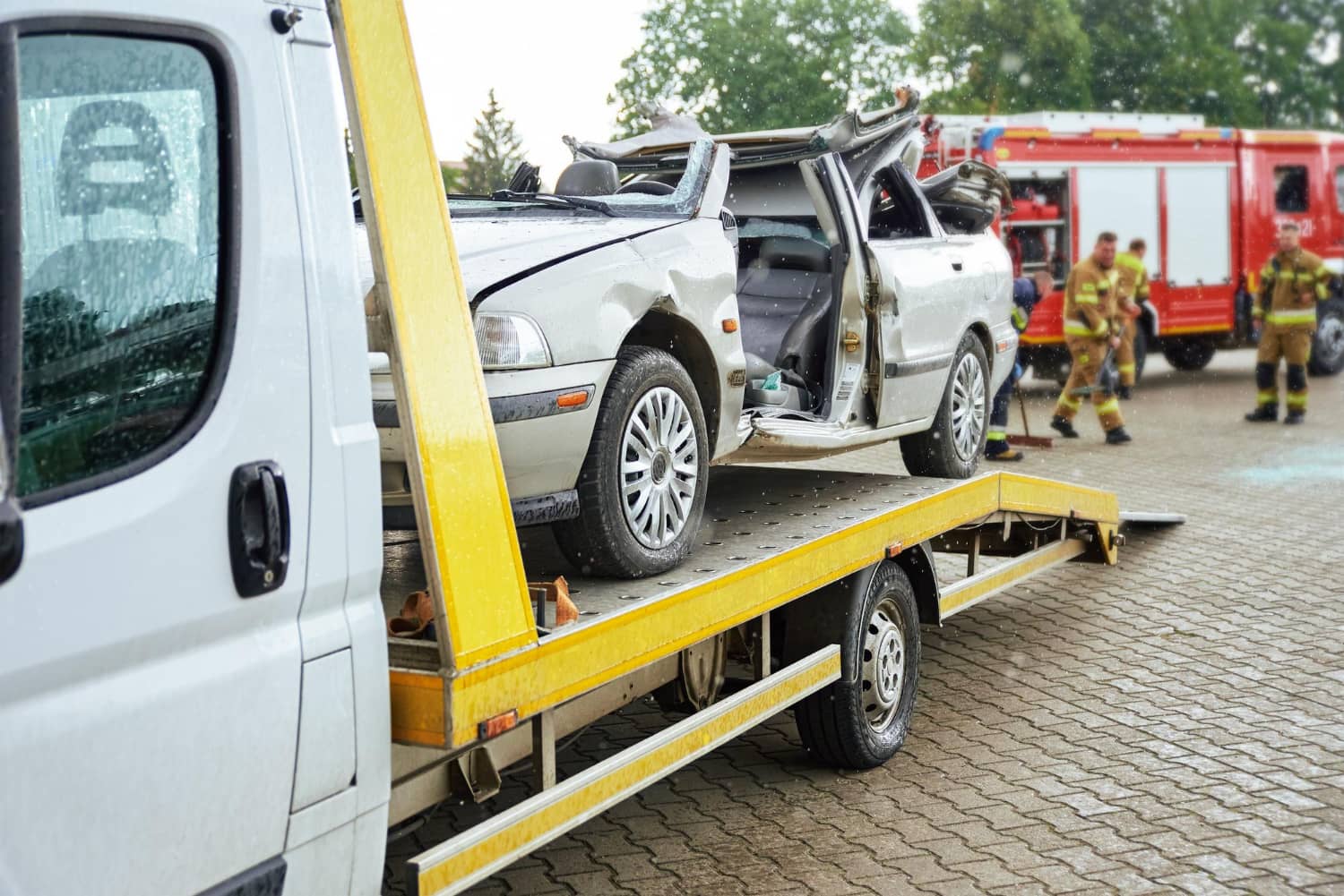 crashed-car-loading-into-tow-truck-after-traffic-accident-road (1)